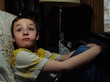 Portrait of boy sitting at home