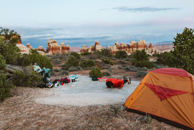 Female camper does pushups at her campsite in the desert of utah