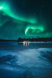 Scenic view of river against sky at night during winter