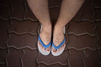 Low section of man standing on footpath