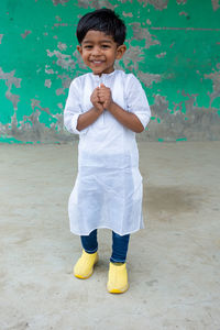 Portrait of smiling boy standing outdoors