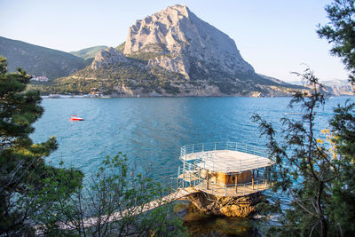 Scenic view of sea and mountains against sky