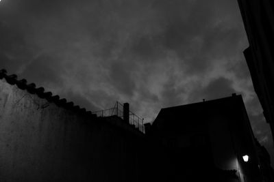 Low angle view of building against cloudy sky