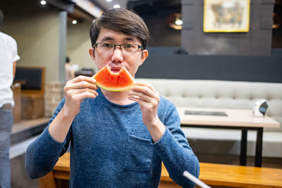 Portrait of man holding ice cream