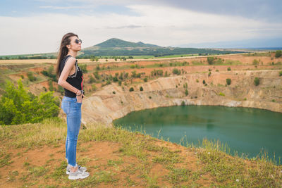 Portrait of young woman standing in water