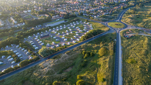 Aerial view of parking lot on green landscape in city