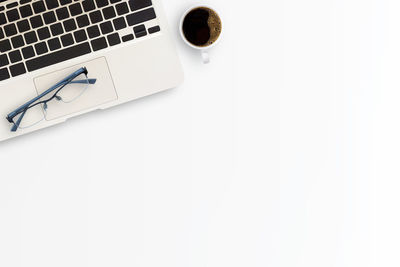 Coffee cup on table against white background