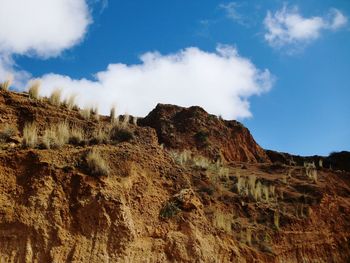 Low angle view of rock formations against sky