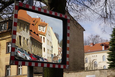 Reflection of cars and buildings on mirror