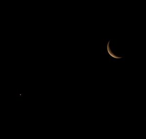 Low angle view of moon against sky at night