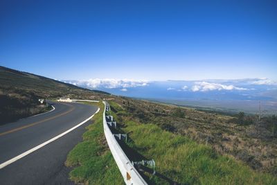 High angle view of road on mountain against blue sky