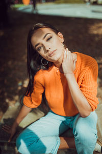 Portrait of young woman sitting outdoors