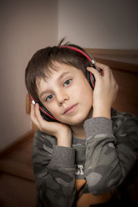 Portrait of boy listening music at home