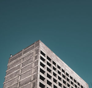 Low angle view of building against clear blue sky