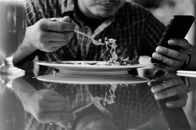 Midsection of man holding ice cream in plate