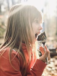 Portrait of young woman drinking outdoors