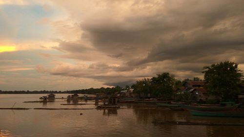 Scenic view of river against sky at sunset