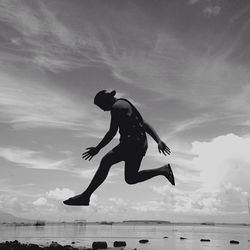 Low angle view of woman jumping in water