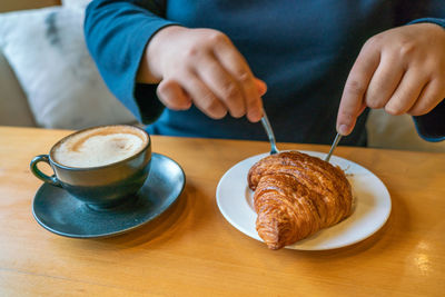 Midsection of man preparing food on table