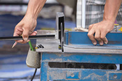 Close-up of man working on metal