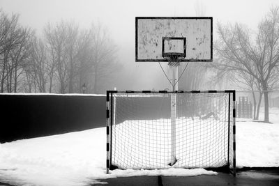 View of basketball hoop on snowy field