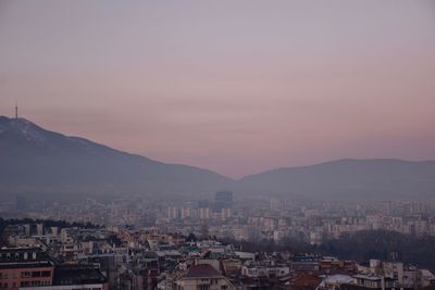 Aerial view of townscape against sky during sunset