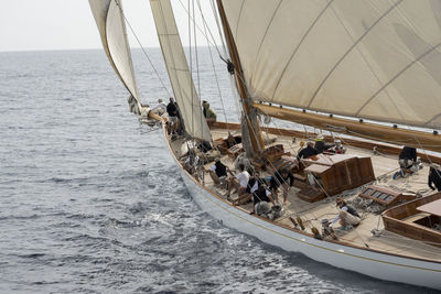 High angle view of people traveling in sail boat on sea