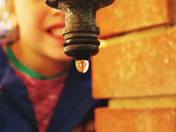 Close-up of water dripping from old pipe