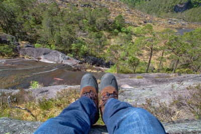 Low section of man standing on mountain