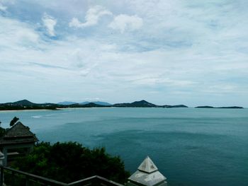 Scenic view of sea and buildings against sky