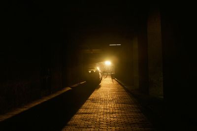 Illuminated tunnel at night