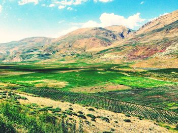 Scenic view of mountains against cloudy sky