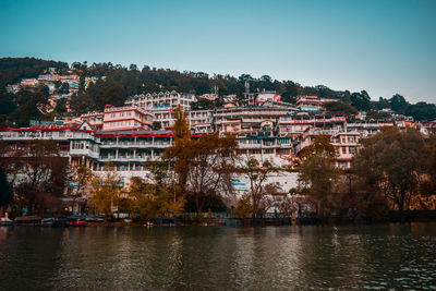 View of townscape by river against sky