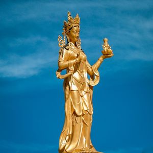 Low angle view of statue against blue sky