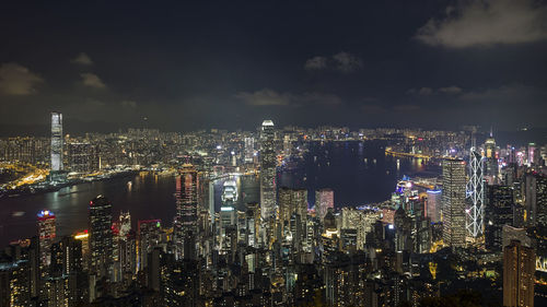 High angle view of illuminated cityscape against sky at night