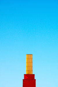 Low angle view of tower against clear blue sky