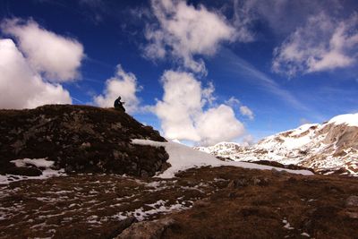 Scenic view of mountains against cloudy sky
