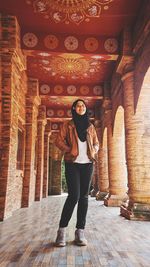 Full length of young woman standing in temple