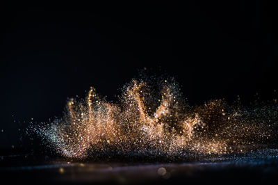 Close-up of firework display against black background