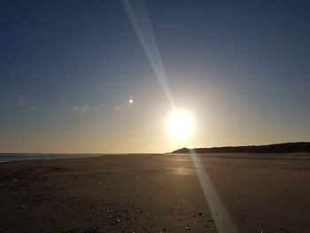 Scenic view of beach against sky during sunset