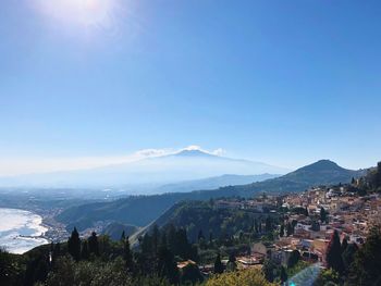 High angle view of town against blue sky