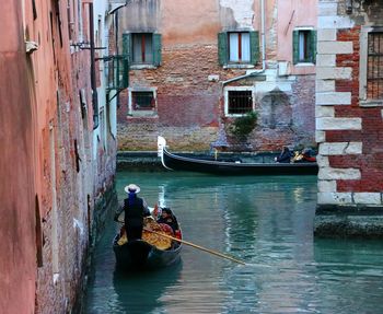 Rear view of people on boat in canal