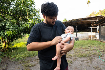 Father and son on plant