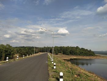 Street by road against sky