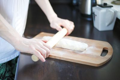 Midsection of person preparing food in kitchen