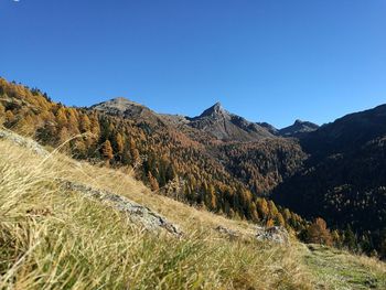 Scenic view of mountains against clear blue sky