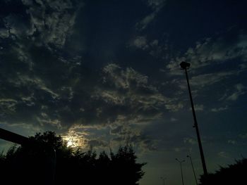 Low angle view of street light against sky at sunset