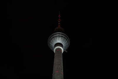 Low angle view of communications tower at night