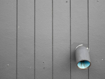 Close-up of light bulb against wall