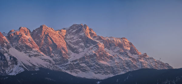 Scenic view of snowcapped mountains against clear sky